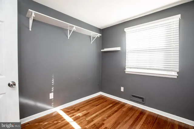 a view of a room with rack on the wall and a window