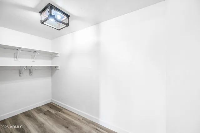 a view of a room with wooden floor and windows