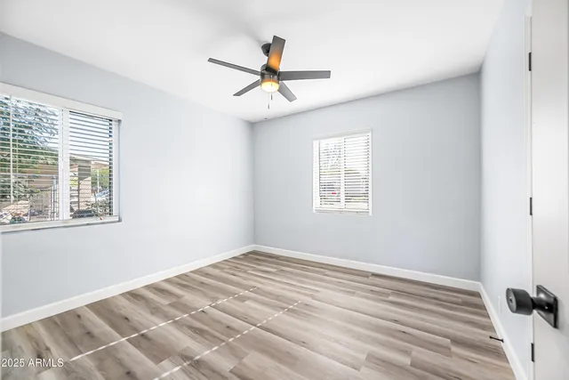 a bathroom with a toilet sink vanity and mirror