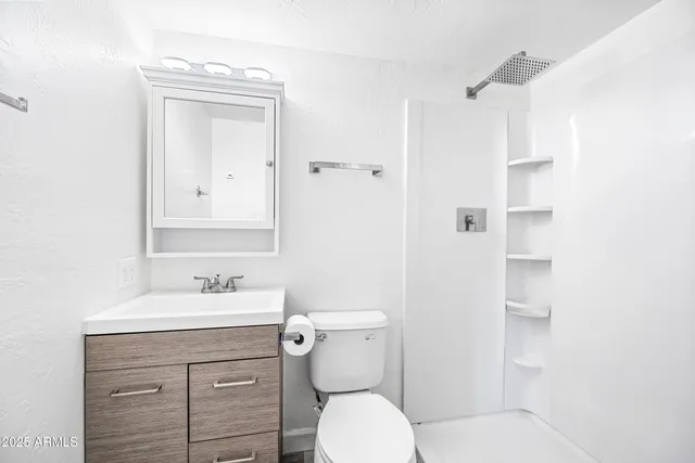 a view of a room with a window and a ceiling fan