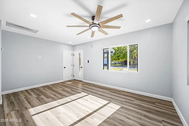 wooden floor in an empty room with a window