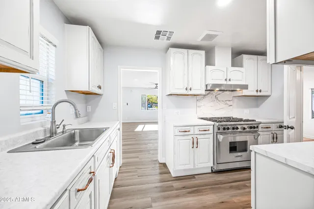 a kitchen with stainless steel appliances kitchen island a refrigerator sink and stove