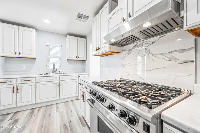 a stove top oven sitting inside of a kitchen