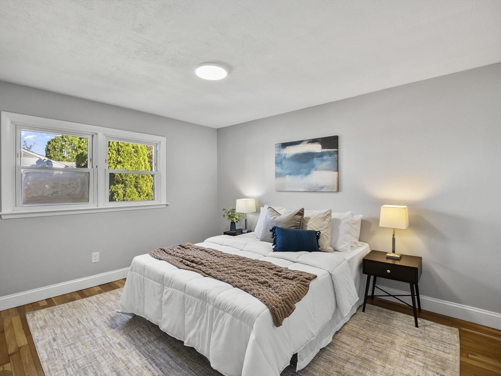 27 Hodgkins Road Rockport, MA 01966 - Photo 15 of 35 a bedroom with a bed and a lamp on dresser