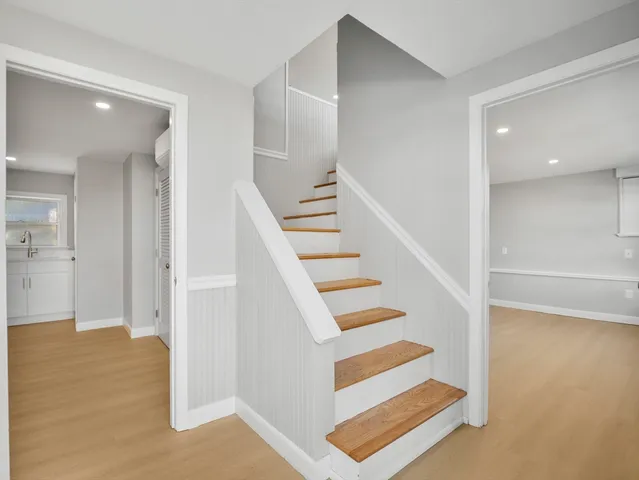 a view of entryway and hall with wooden floor