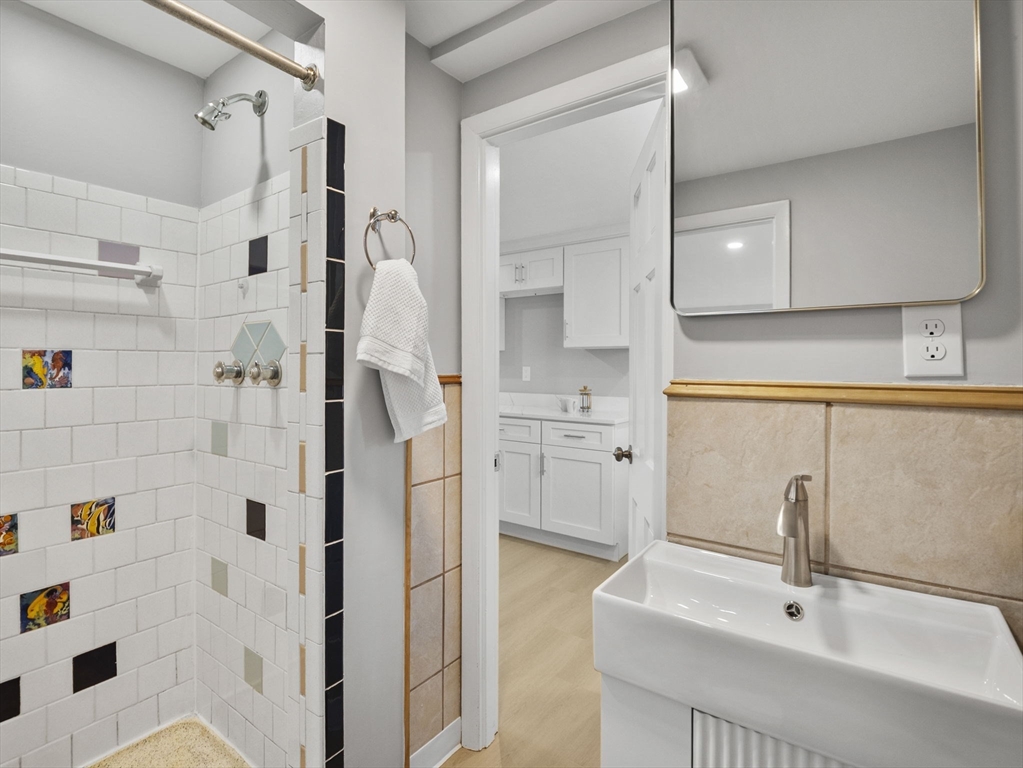27 Hodgkins Road Rockport, MA 01966 - Photo 22 of 35 a bathroom with a sink a mirror and shower
