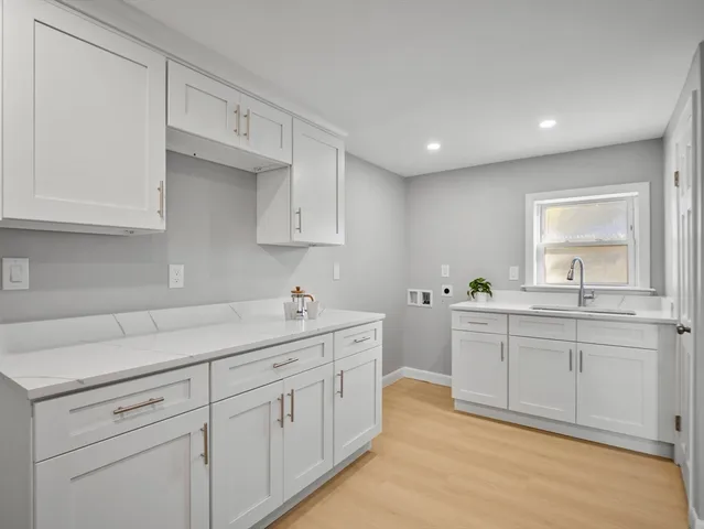 a kitchen with sink and cabinets