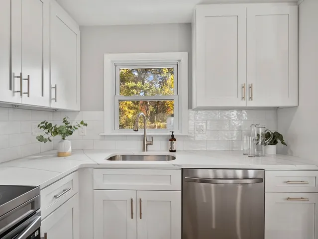 a kitchen with a sink cabinets and window