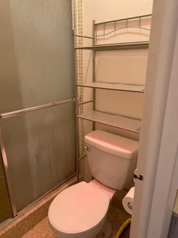 a bathroom with a toilet and a shower
