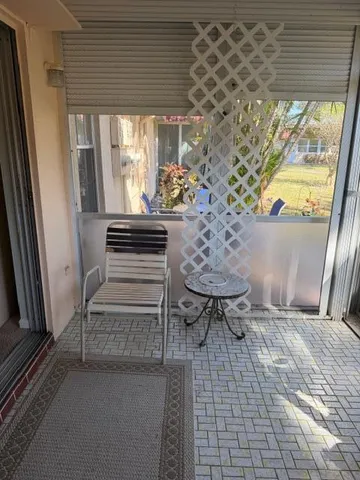 a view of balcony with furniture