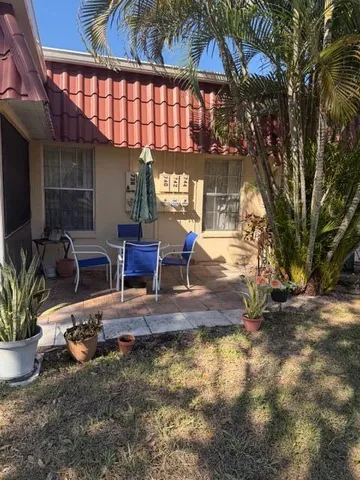 a view of a chairs and table in the patio