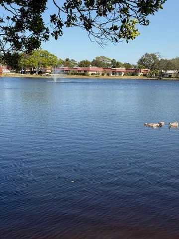 an aerial view of a houses with a lake view