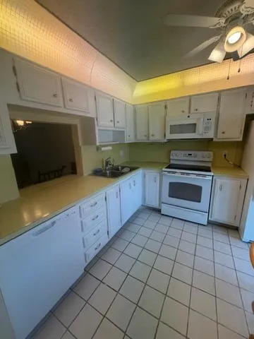 a kitchen with stainless steel appliances a sink a stove top oven a counter space and cabinets