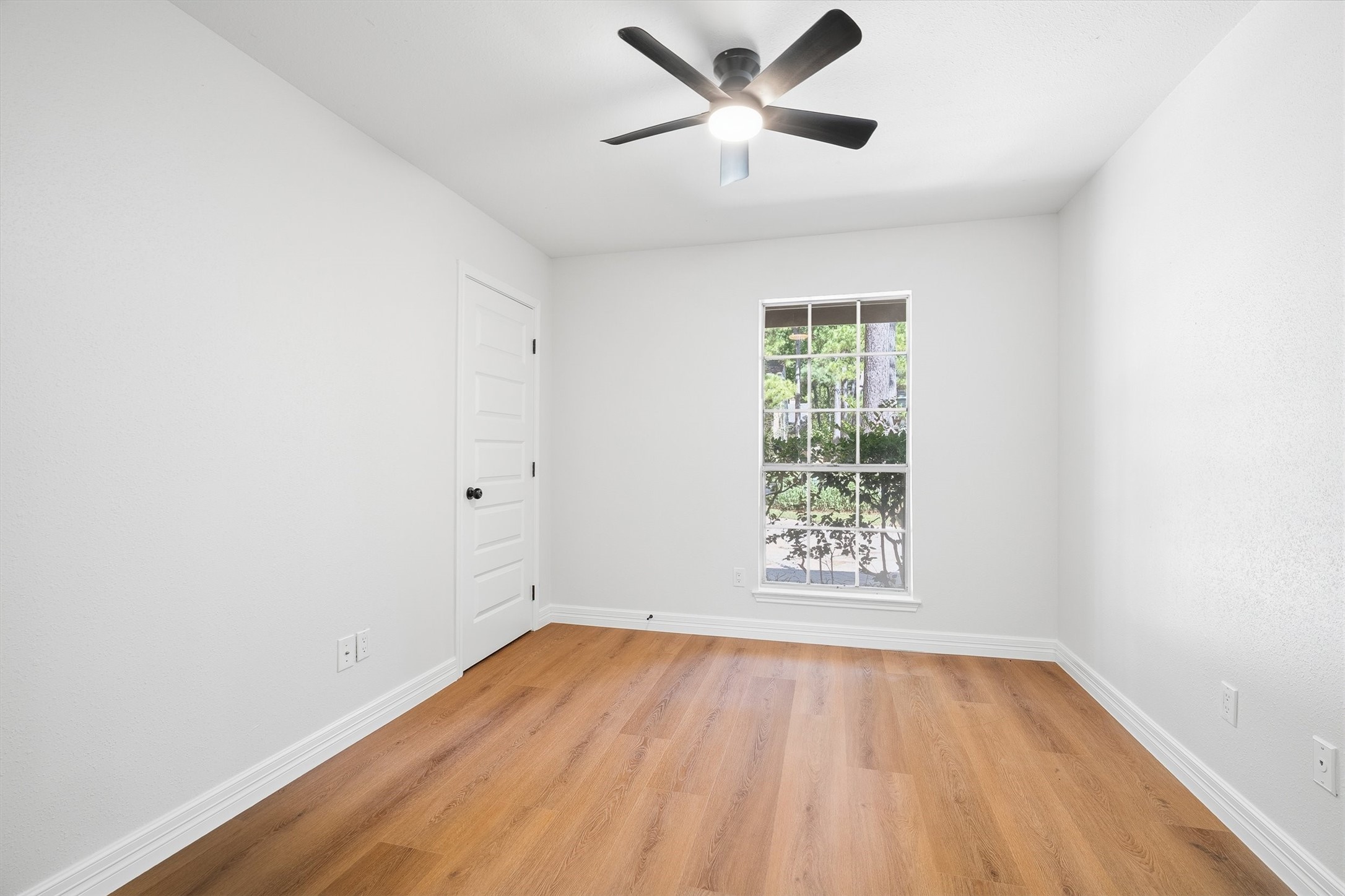 3 Still Corner Place Spring, TX 77381 - Photo 20 of 34 Tucked away near the primary suite, this second bedroom offers a bright, flexible space with a window looking out over the greenery outside.