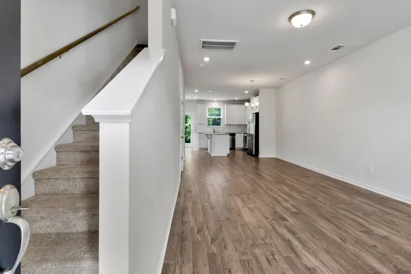 a view of kitchen with furniture and wooden floor