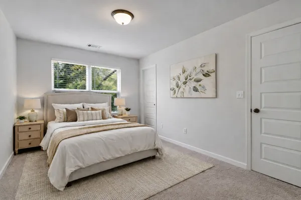 a bedroom with a bed and a painting on the wall