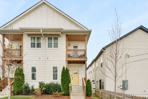 a view of house with a yard