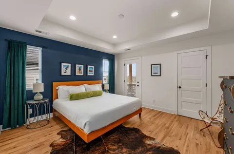 a bedroom with a large bed and a night stand