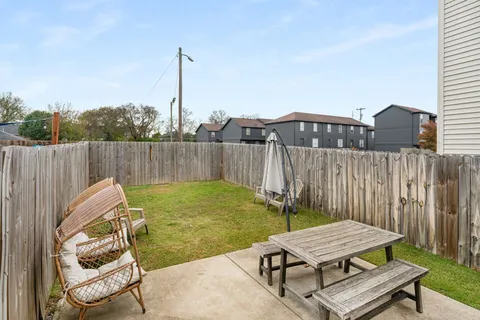 a backyard of a house with table and chairs