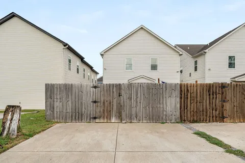 a view of a house with wooden fence