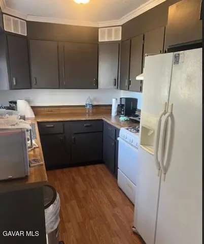 a kitchen with stainless steel appliances a refrigerator sink and cabinets