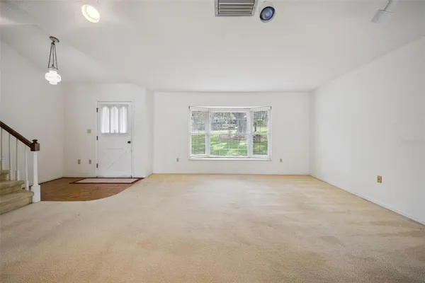 an empty room with a empty space and windows