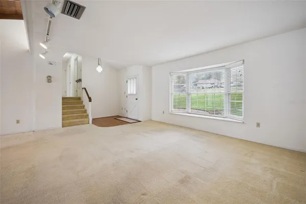 a view of an empty room with a window
