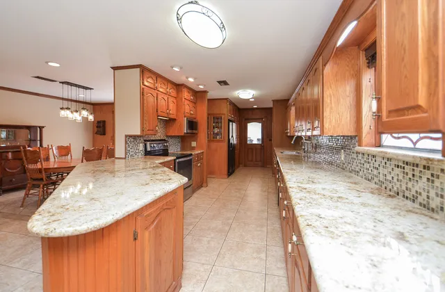 a large kitchen with kitchen island a large window