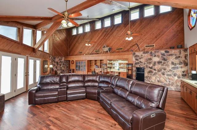 a roof deck with couches and wooden floor