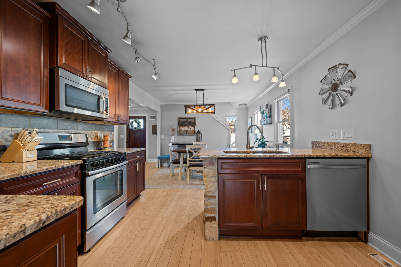 311 Ohio Avenue St. Charles, IL 60174 - Photo 11 of 20 a kitchen with stainless steel appliances granite countertop a sink a stove and a wooden floors