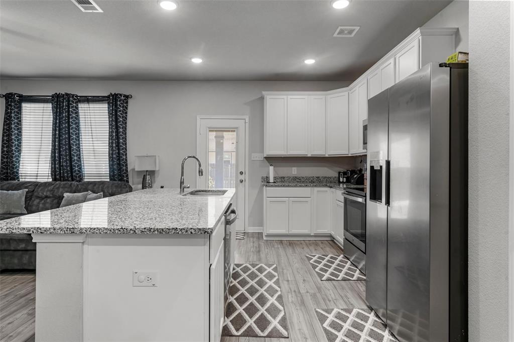 3525 Beutel Road Lorena, TX 76655 - Photo 8 of 34 a kitchen with a refrigerator sink and cabinets