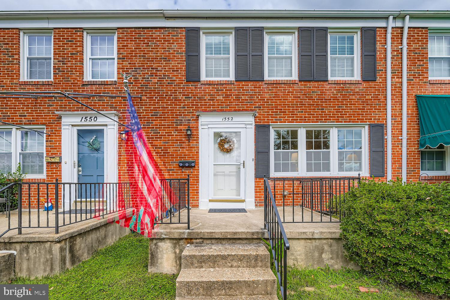 1552 Cottage Lane Towson, MD 21286 - Photo 2 of 32 a front view of a house with a yard