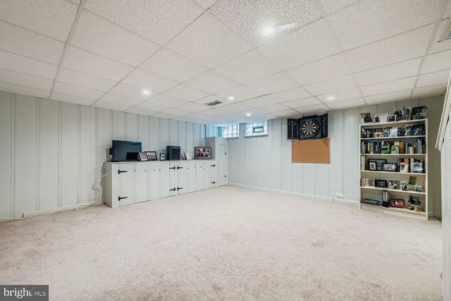 a view of an empty room with a cabinet and a window