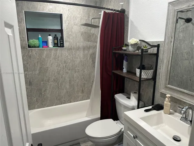 a bathroom with a toilet a sink and bathtub