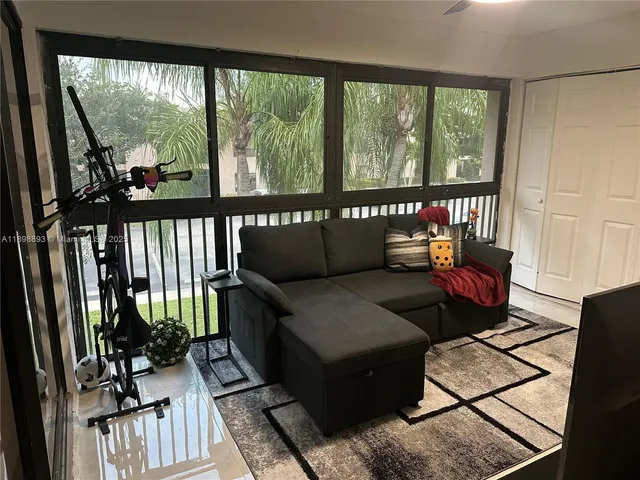 a living room with furniture tv and wooden floor