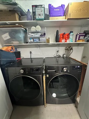 a utility room with sink dryer and washer