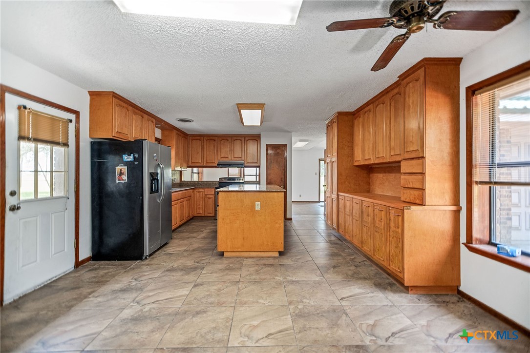 181 Pecan Street Port Lavaca, TX 77979 - Photo 5 of 34 a kitchen view with stainless steel appliances a refrigerator and a stove top oven