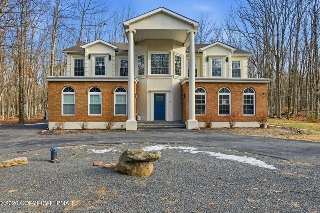 a view of a livingroom with stairs and furniture