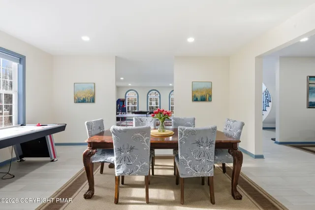 a view of a patio with couches chairs and a wooden floor