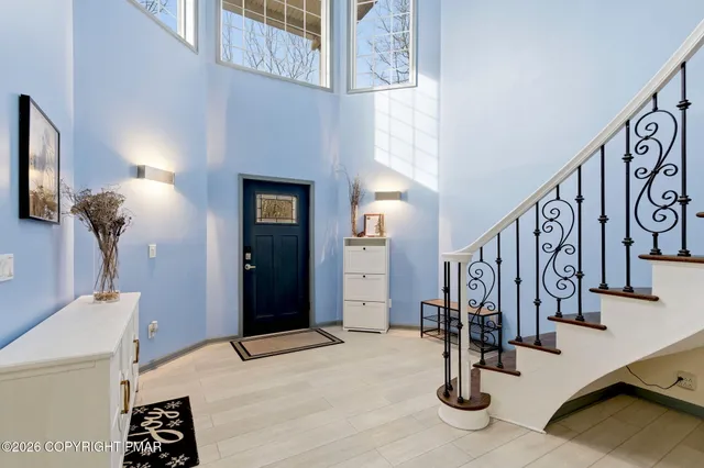 a living room with furniture fireplace and a large window