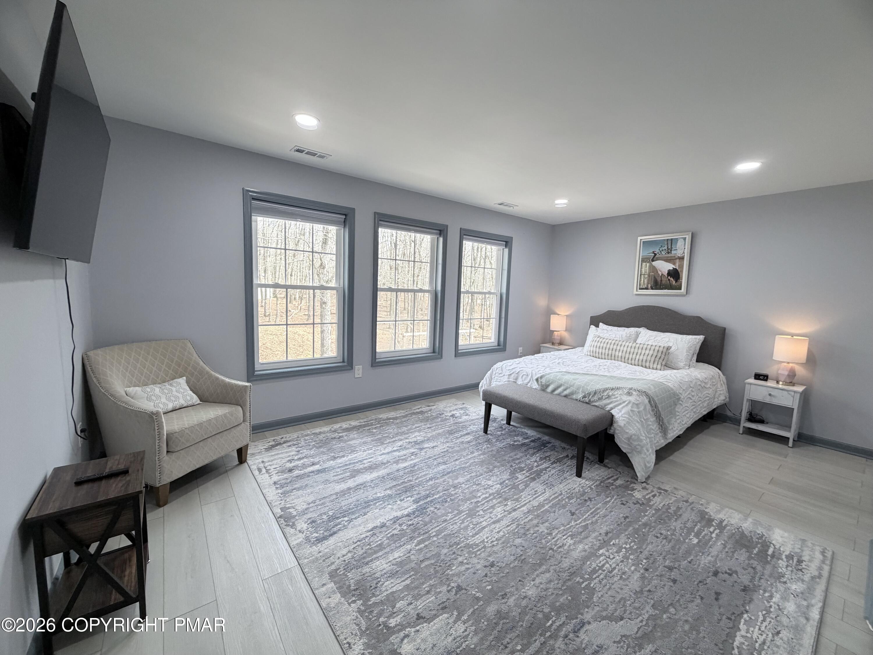 74 Buckhill Road Albrightsville, PA 18210 - Photo 49 of 65 a spacious bedroom with a bed and a large window