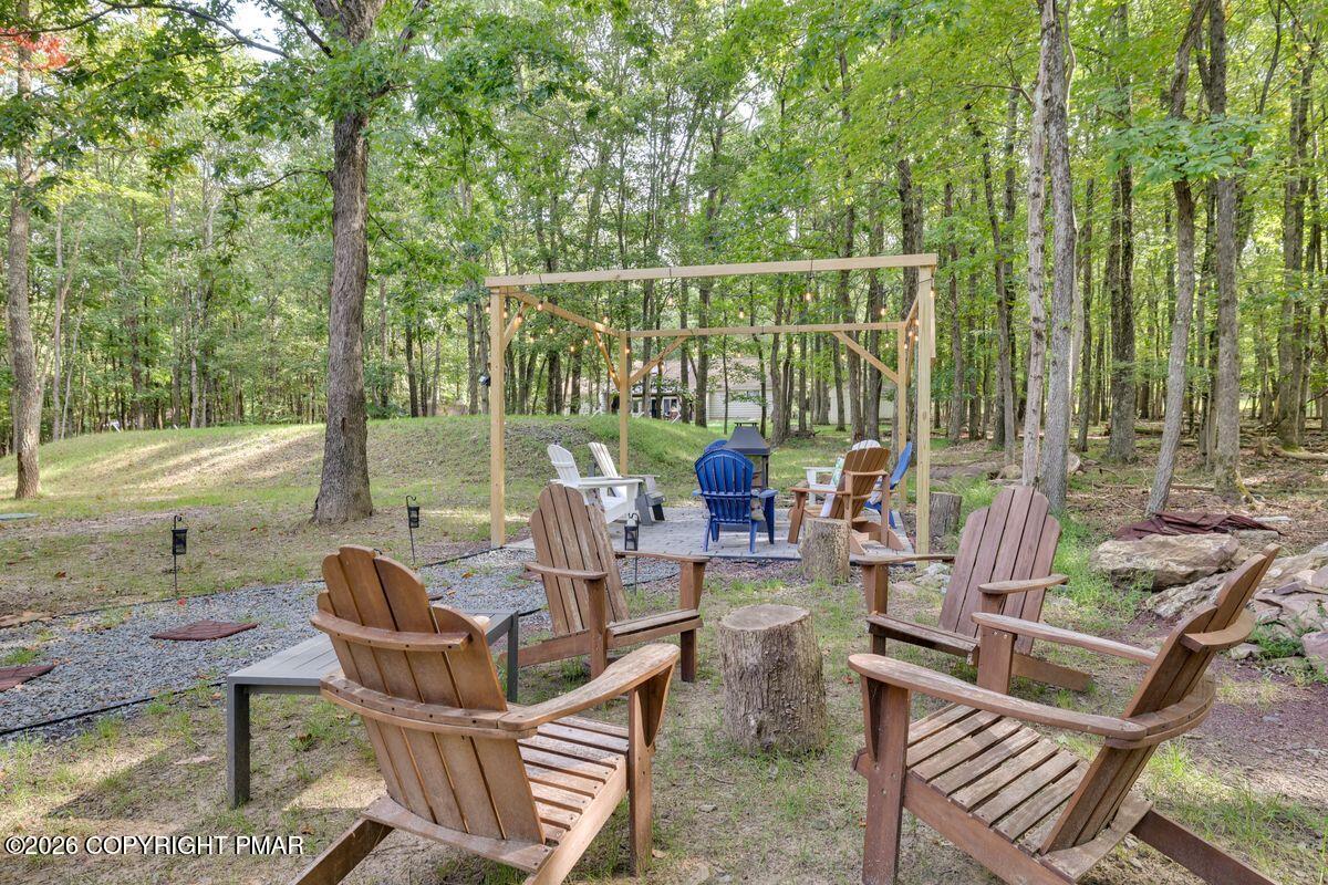 74 Buckhill Road Albrightsville, PA 18210 - Photo 55 of 65 a view of a patio with couches chairs and a wooden floor