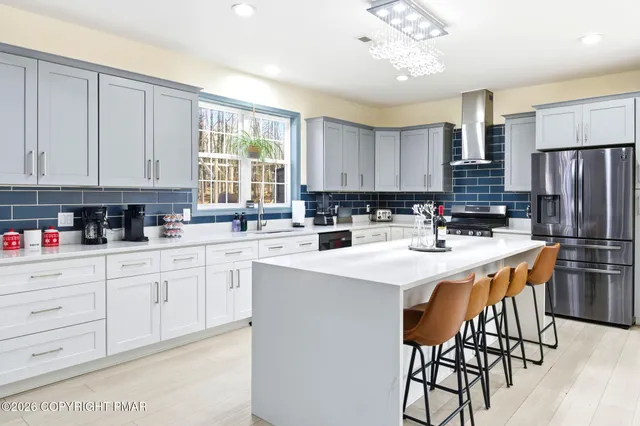 a bathroom with a tub a sink and a shower