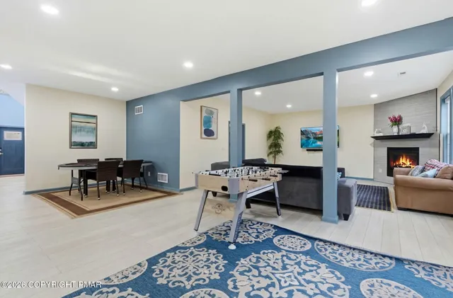 a living room with furniture and a chandelier