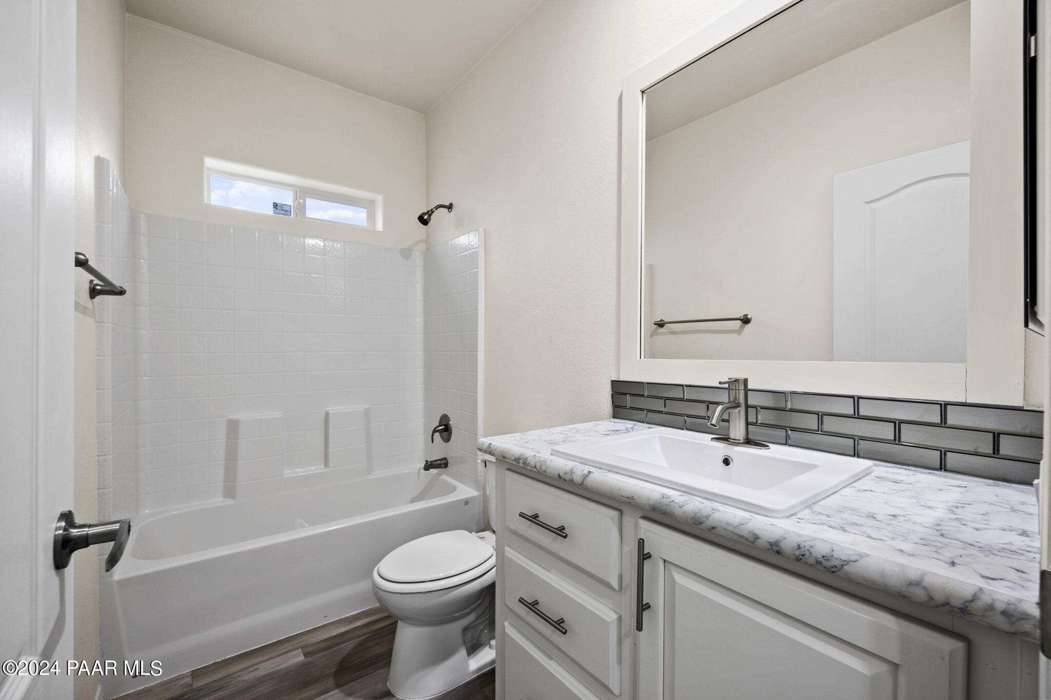 25784 Riesling Lane Paulden, AZ 86334 - Photo 8 of 15 a bathroom with a sink a toilet a mirror a vanity and bathtub