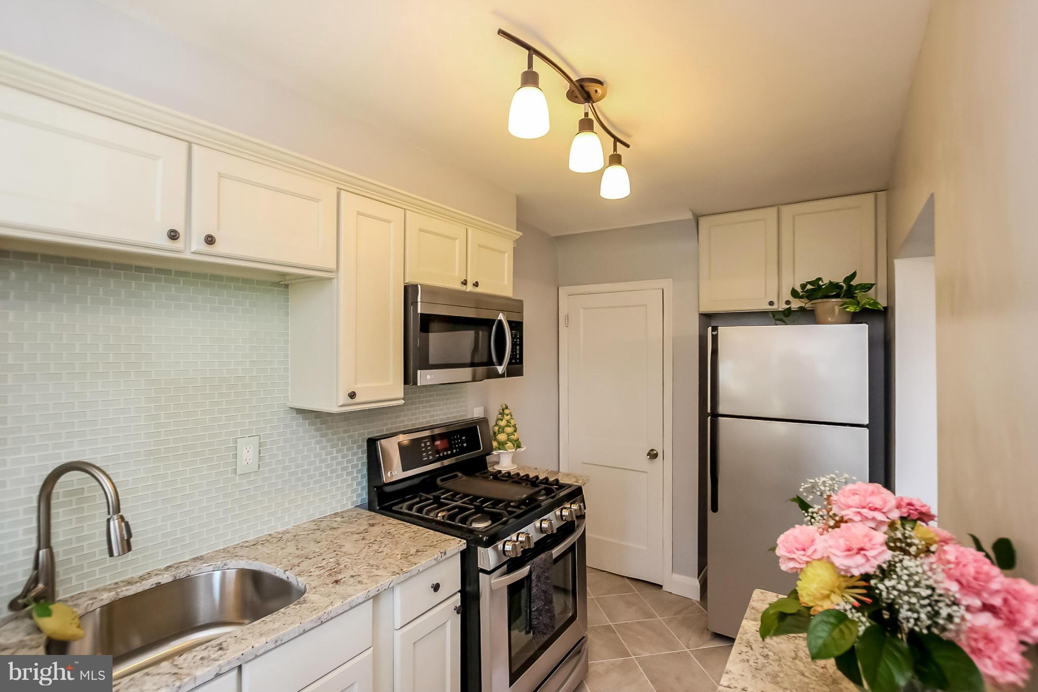 8329 Kavanagh Road Baltimore, MD 21222 - Photo 11 of 30 a kitchen with a sink stainless steel appliances and cabinets