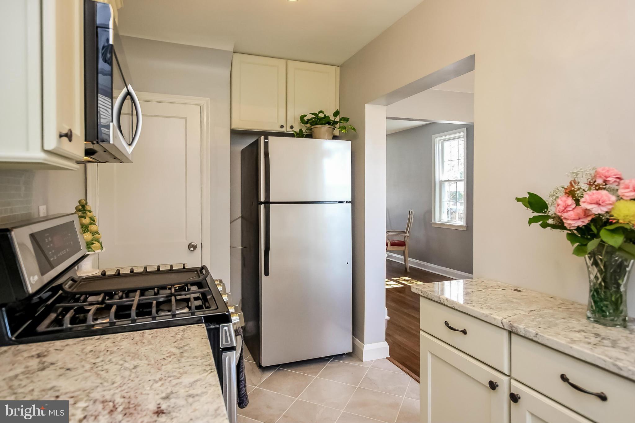 8329 Kavanagh Road Baltimore, MD 21222 - Photo 12 of 30 a kitchen with sink refrigerator and stove