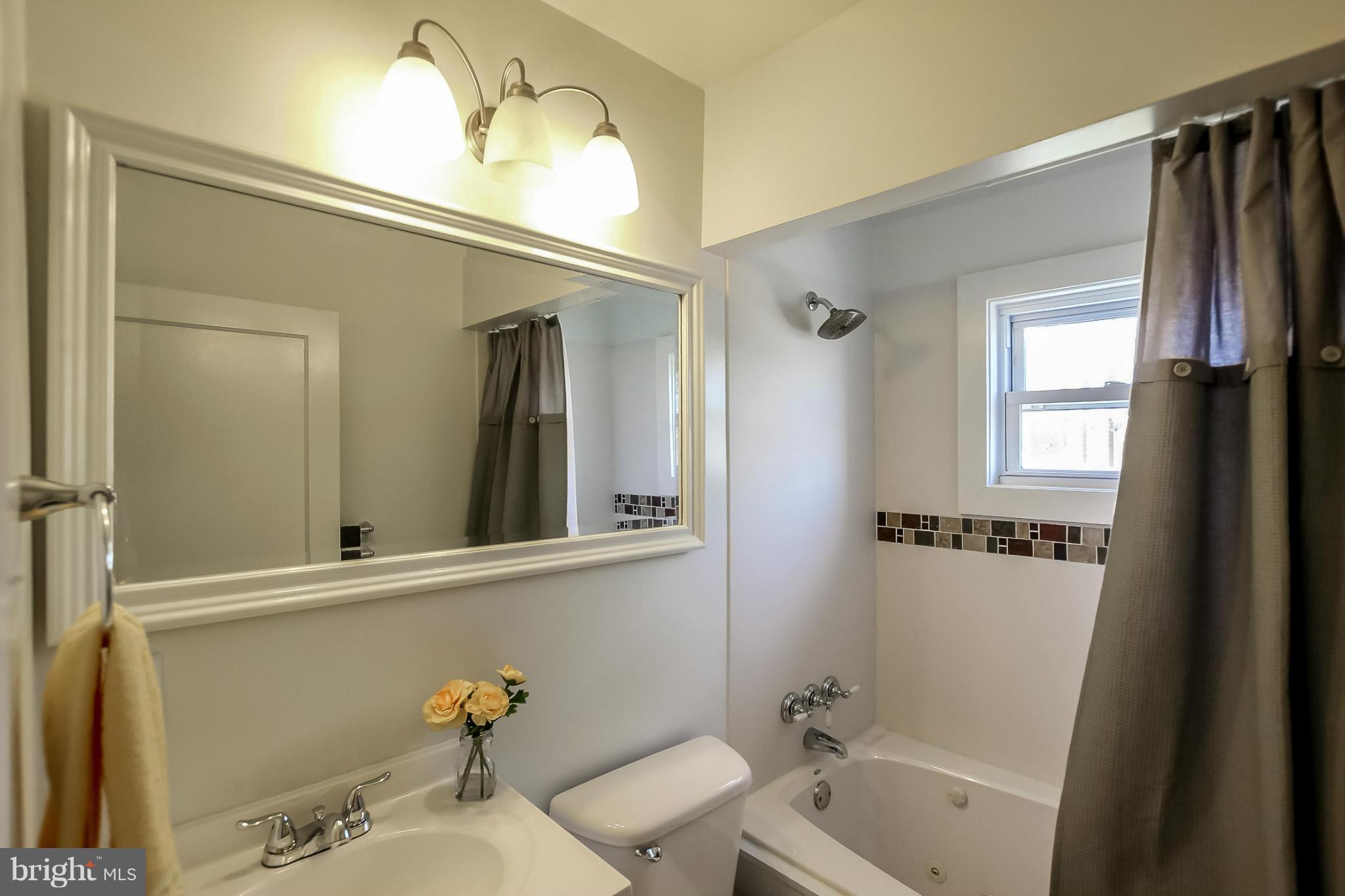 8329 Kavanagh Road Baltimore, MD 21222 - Photo 17 of 30 a bathroom with a tub shower and sink