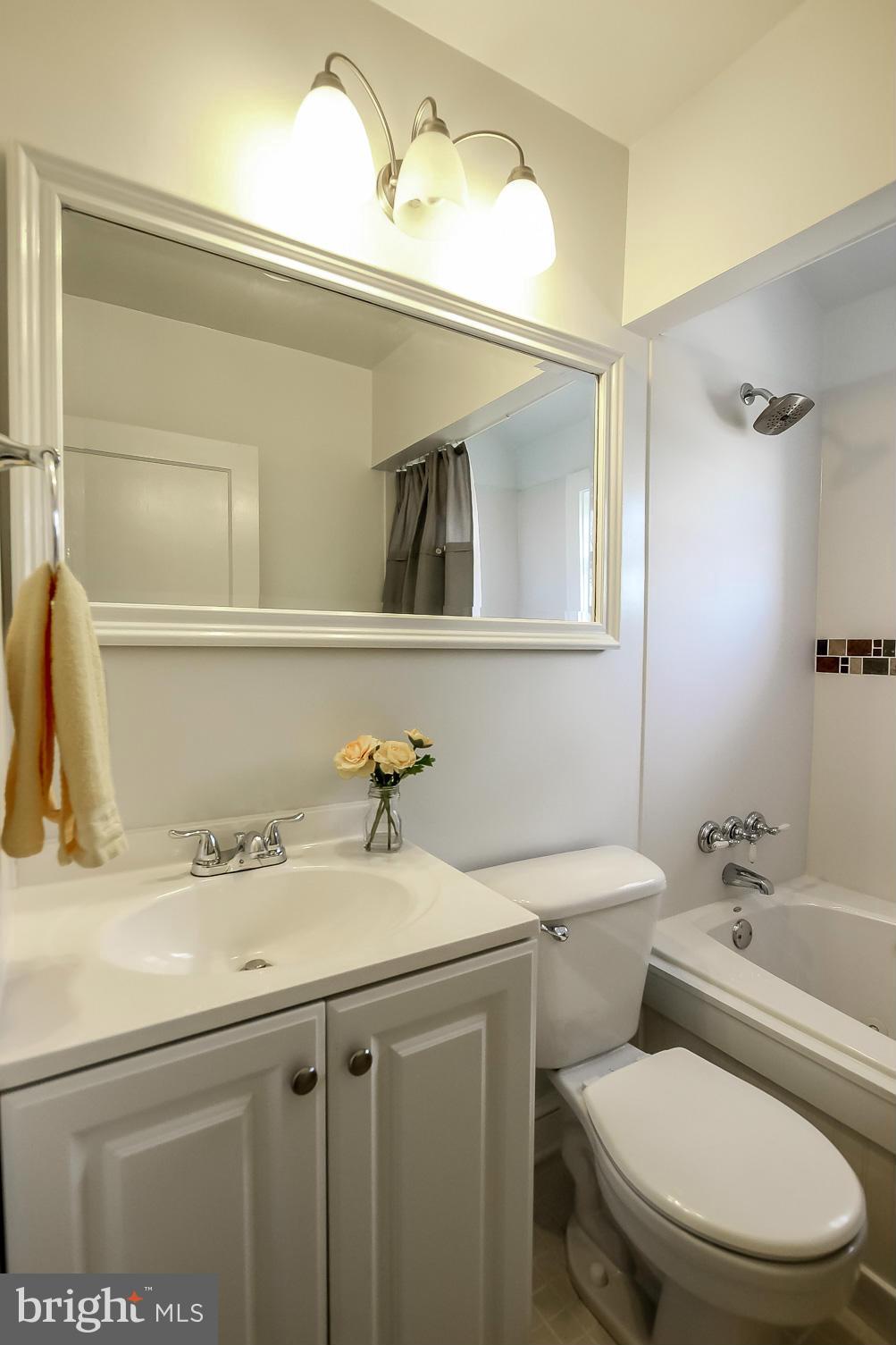 8329 Kavanagh Road Baltimore, MD 21222 - Photo 18 of 30 a bathroom with a granite countertop toilet sink and mirror