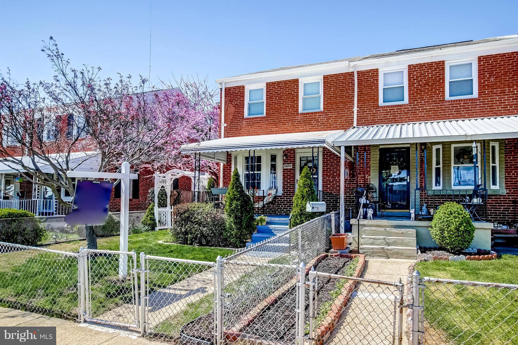8329 Kavanagh Road Baltimore, MD 21222 - Photo 3 of 30 front view of a brick house with a yard